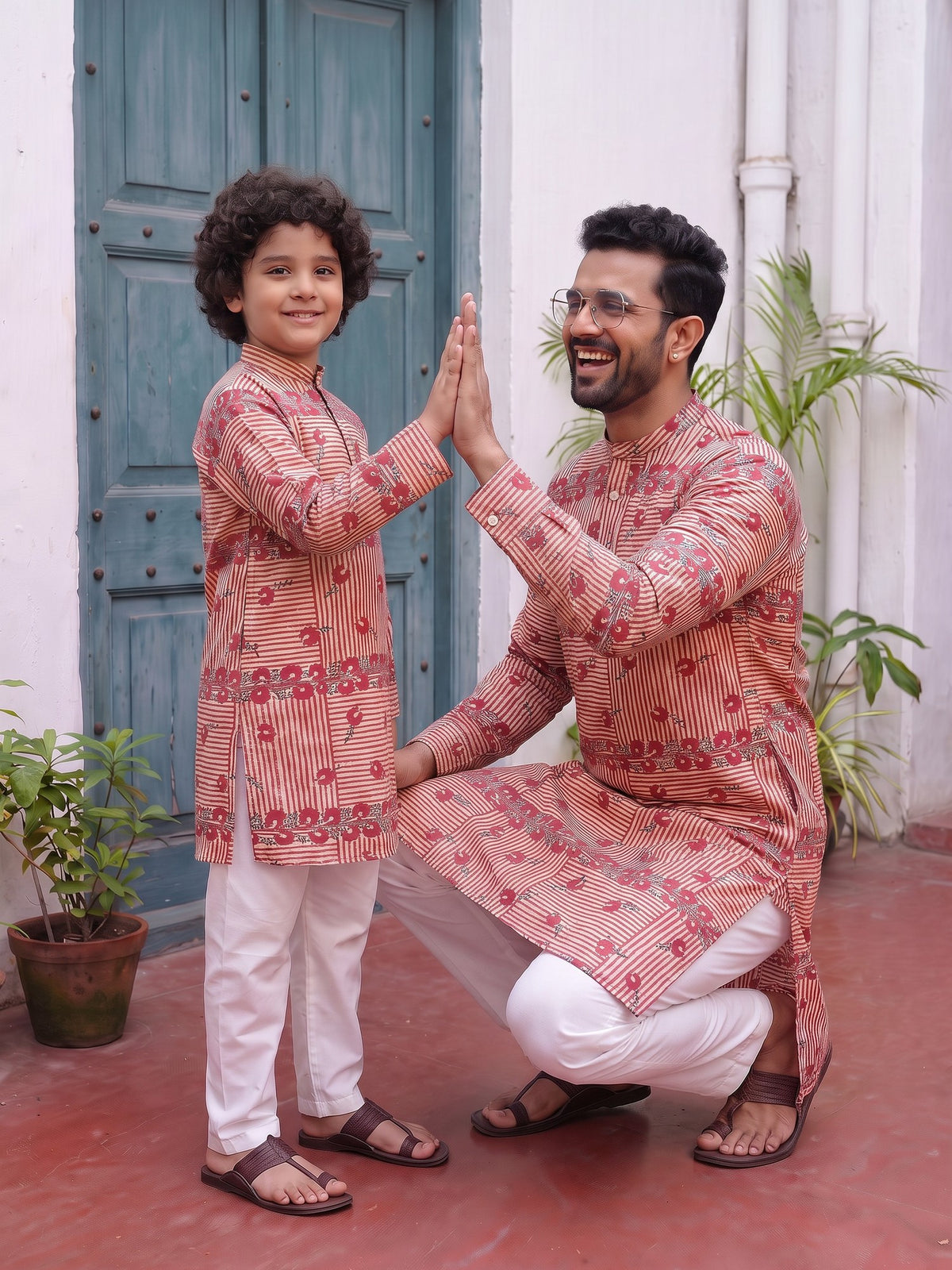 Father and son high five in matching kurtas