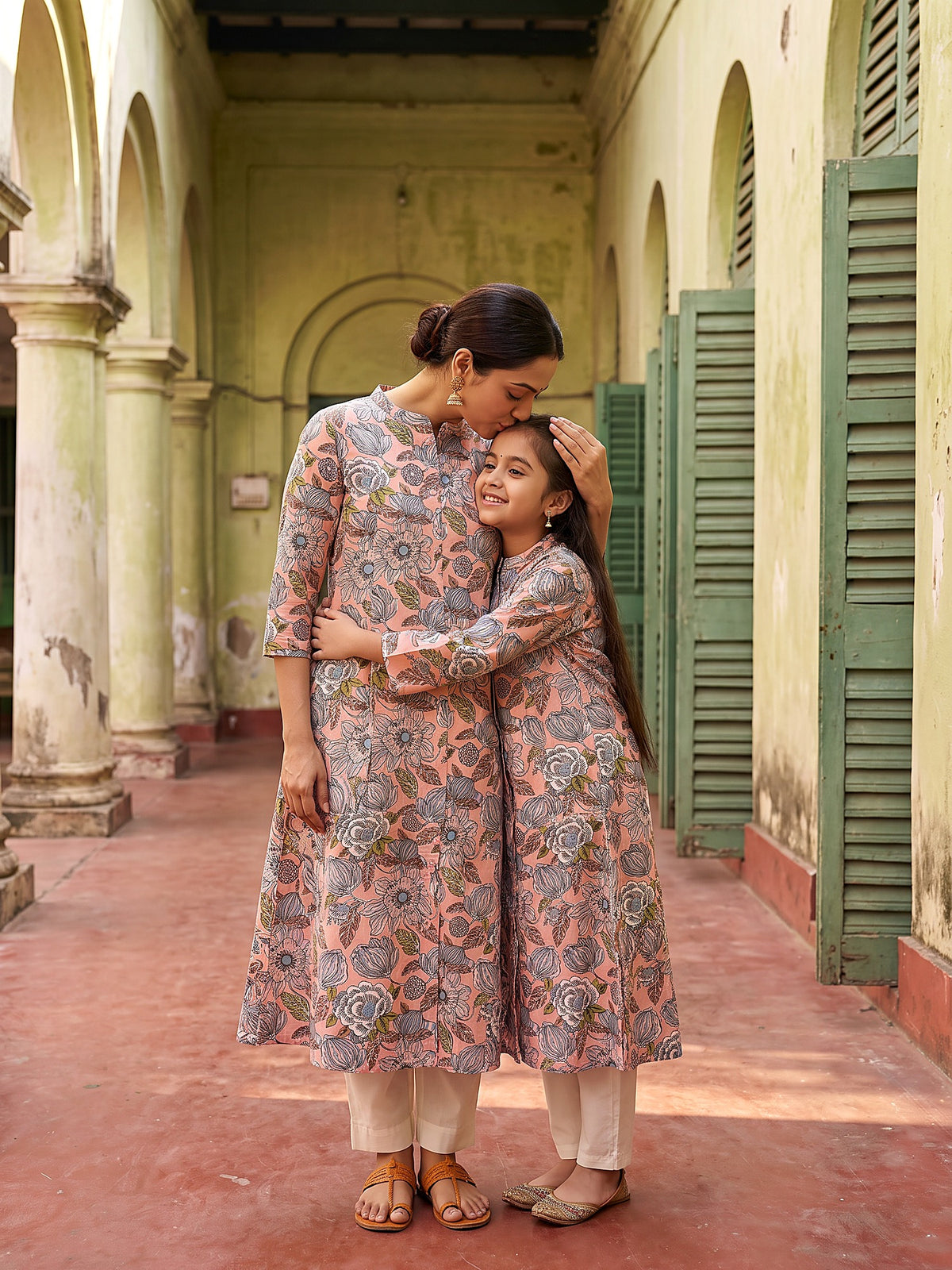Mother hugging daughter in matching kurtis