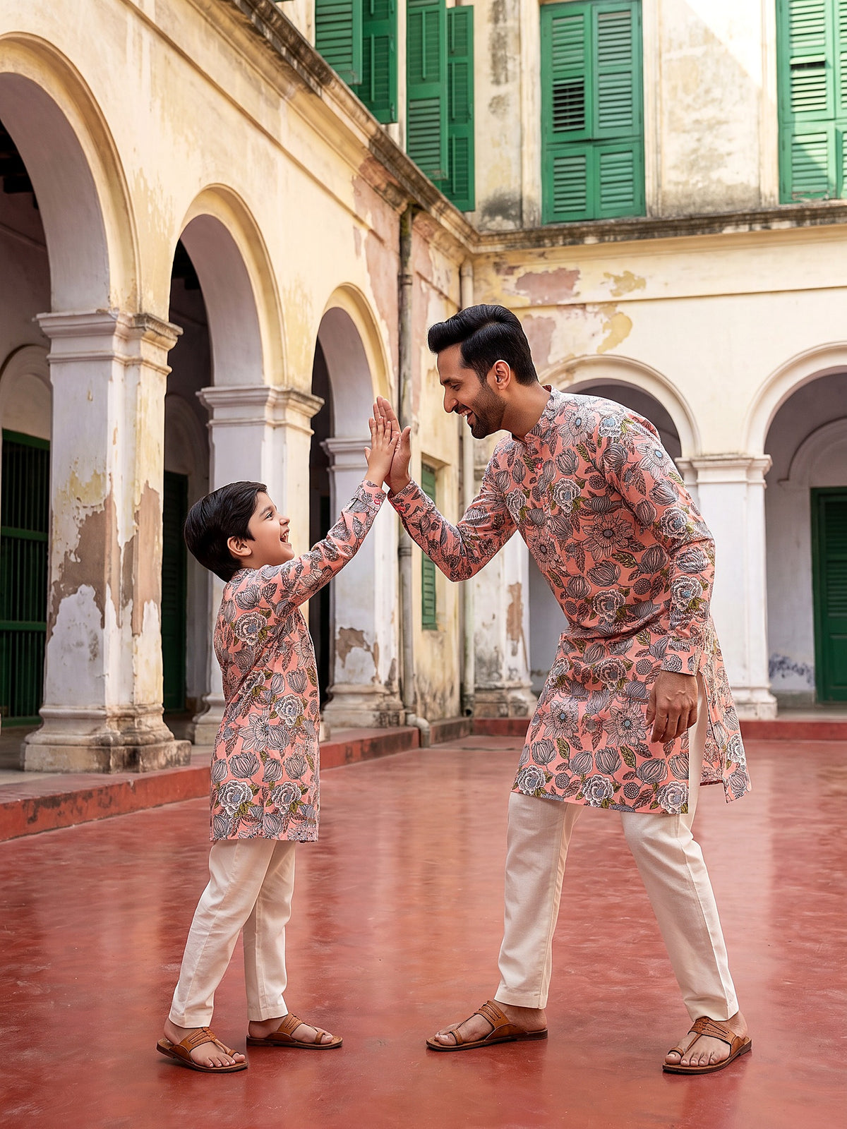 Father and son playful moment in matching kurtas
