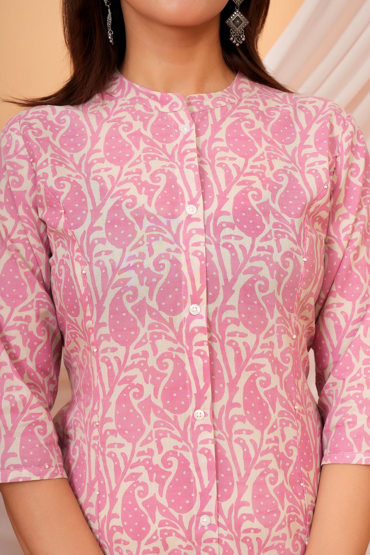 Close-up of mandarin collar, buttons and pink paisley print