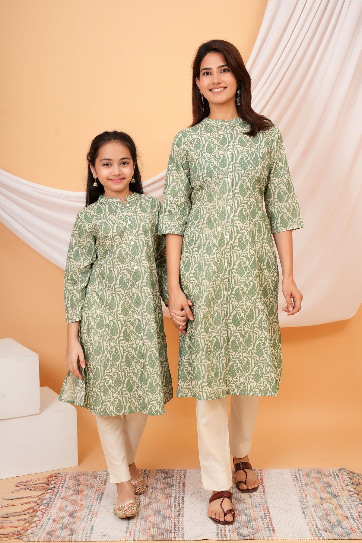 Maa and Beti in matching sage green paisley printed kurtis
