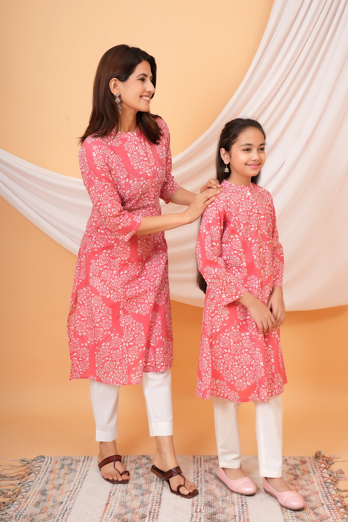 Maa and Beti in matching pink floral jaal printed kurtis