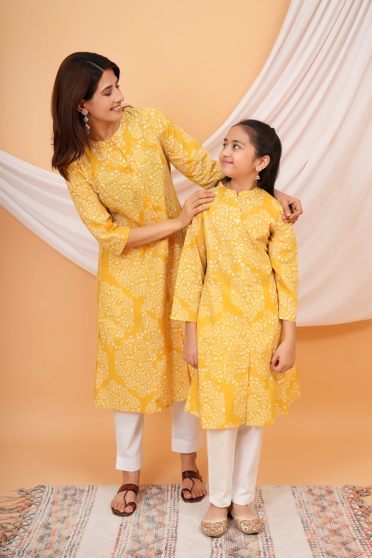 Maa and Beti in matching yellow floral jaal printed kurtis