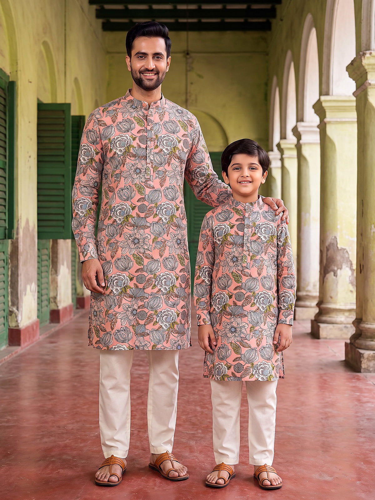 Father and son in matching pink floral kurtas
