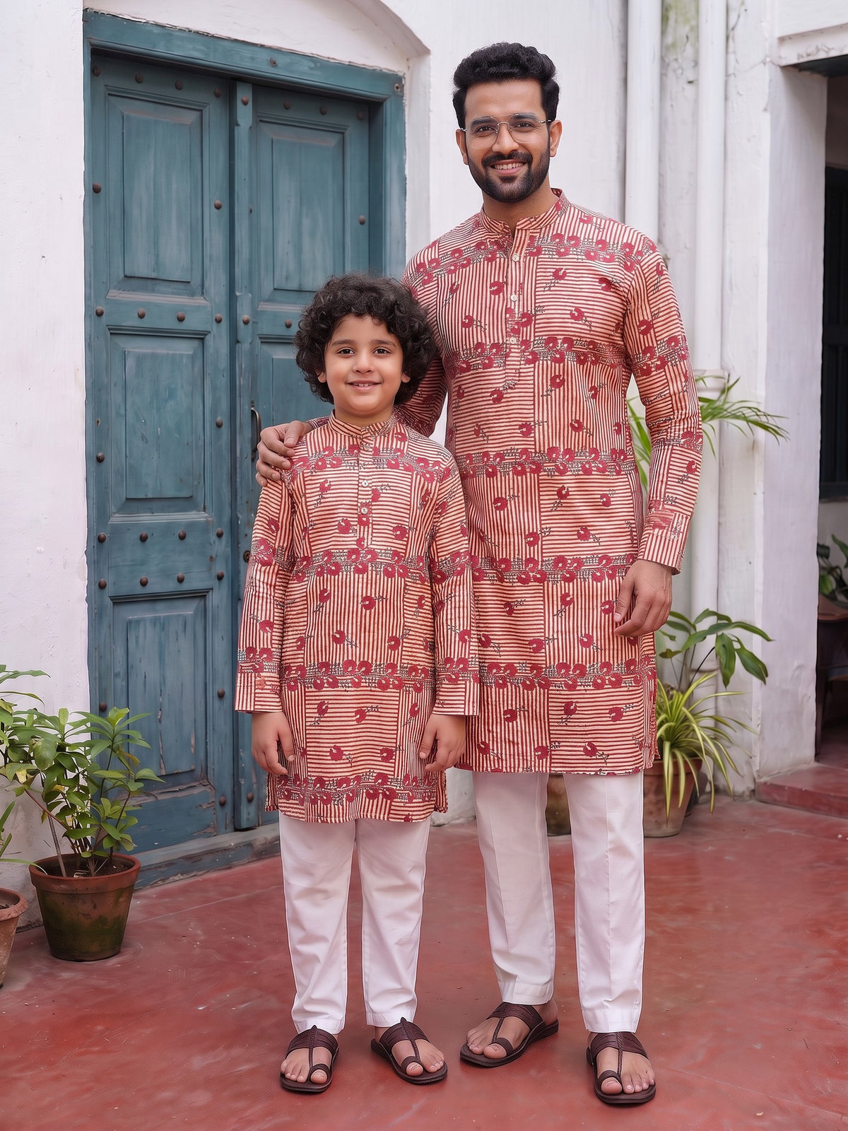 Father and son in matching red stripe floral kurtas