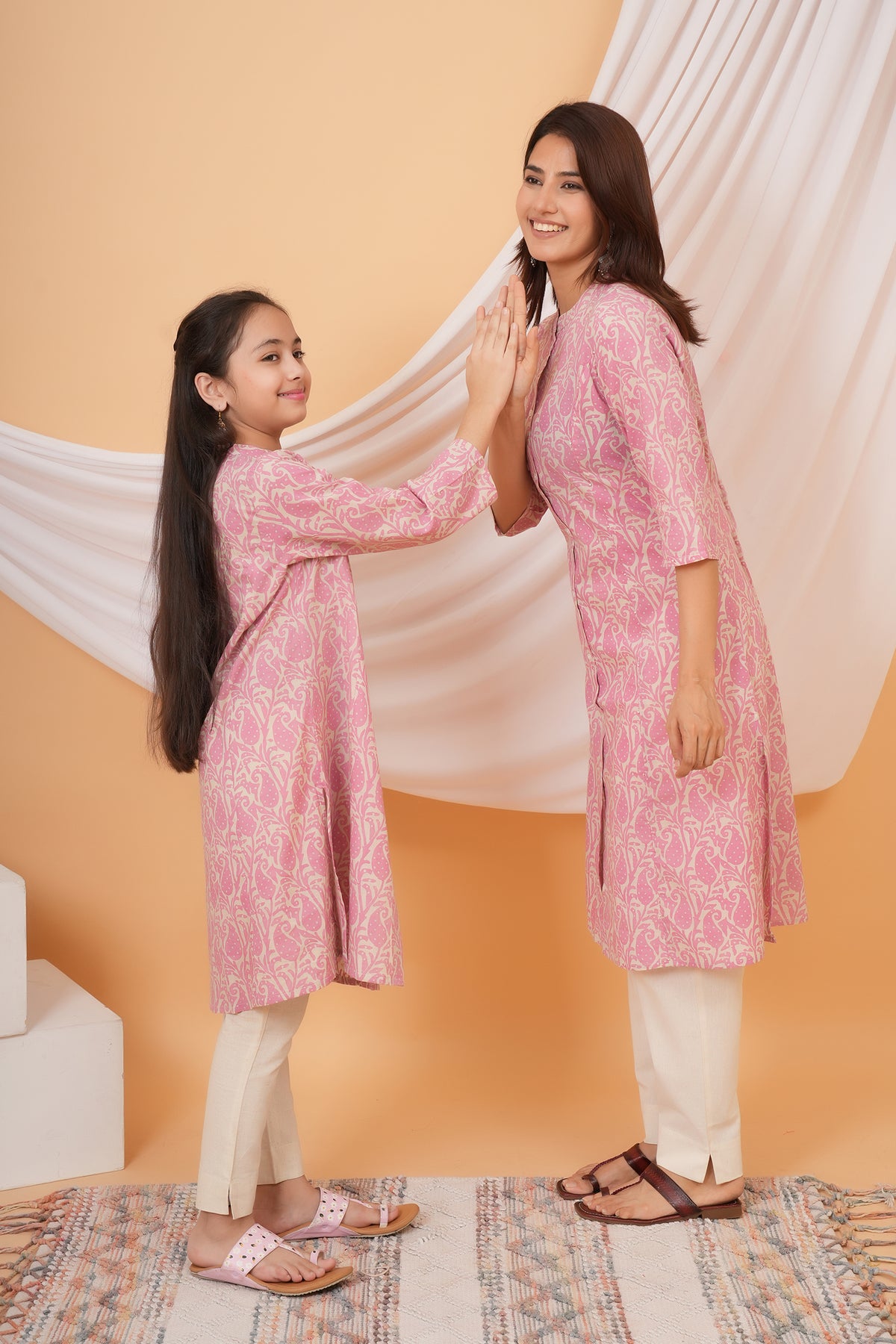 Mother and daughter high five in pink paisley kurtis
