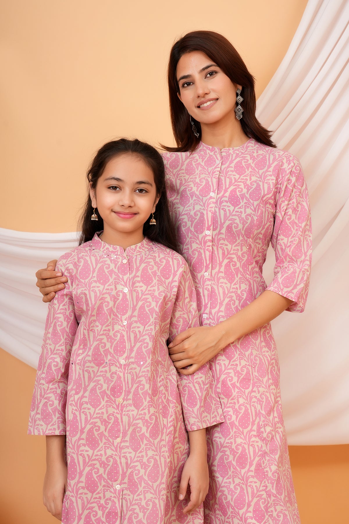 Close view of mother and daughter in pink paisley kurtis