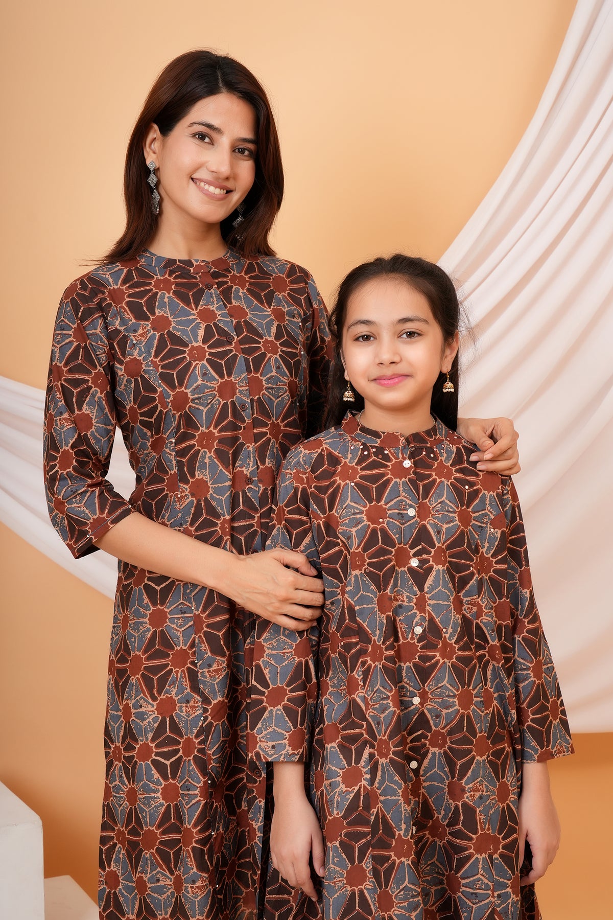 Close view of mother and daughter in geometric print kurtis