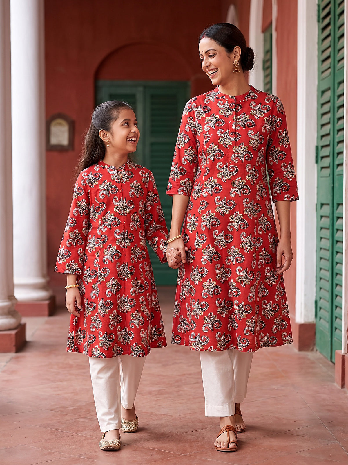 Maa Beti bold red kurtis walking hand in hand