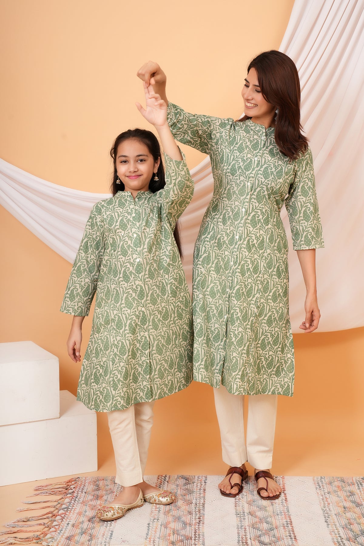 Maa and Beti in matching sage green paisley printed kurtis
