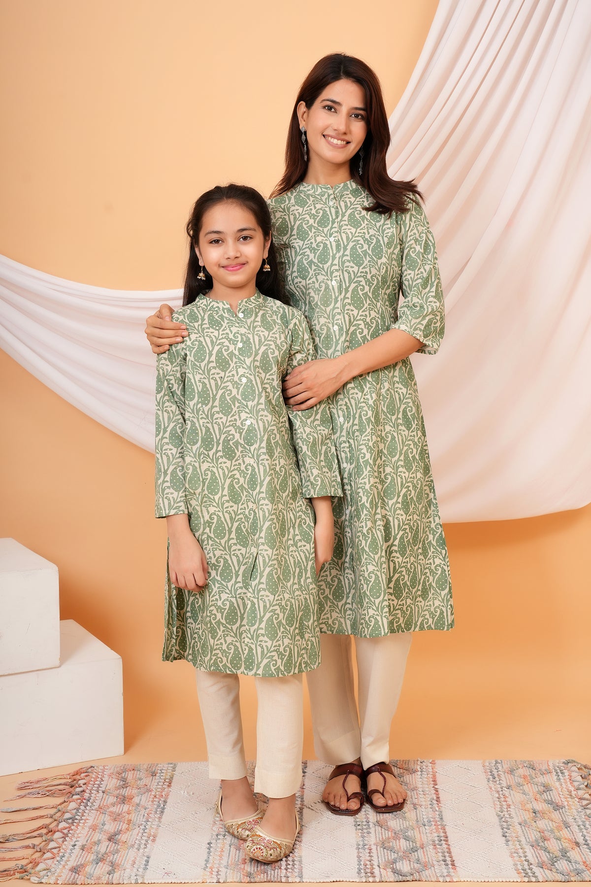 Maa and Beti in matching sage green paisley printed kurtis