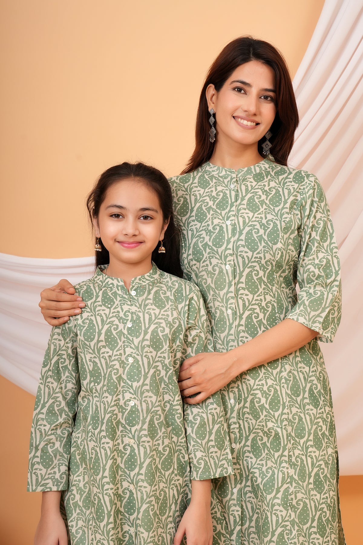 Maa and Beti in matching sage green paisley printed kurtis