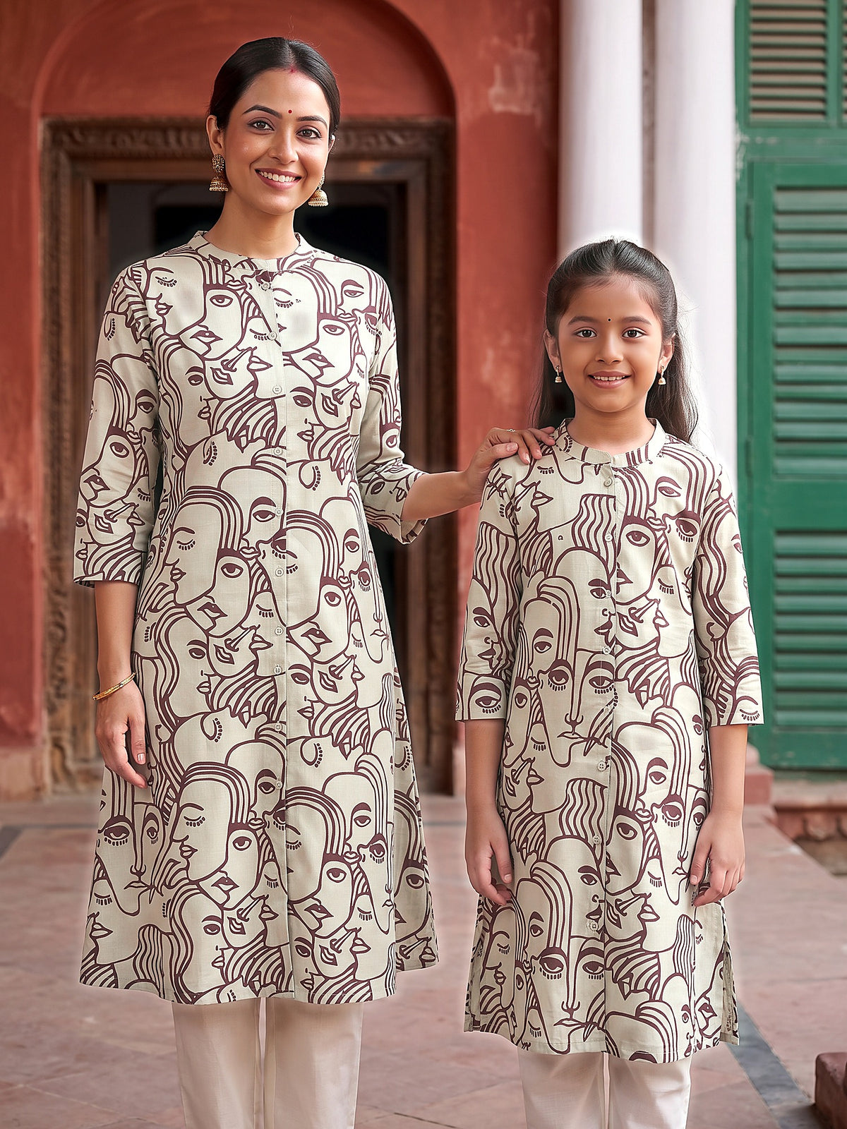 Mother and daughter in matching maroon face art printed kurtis