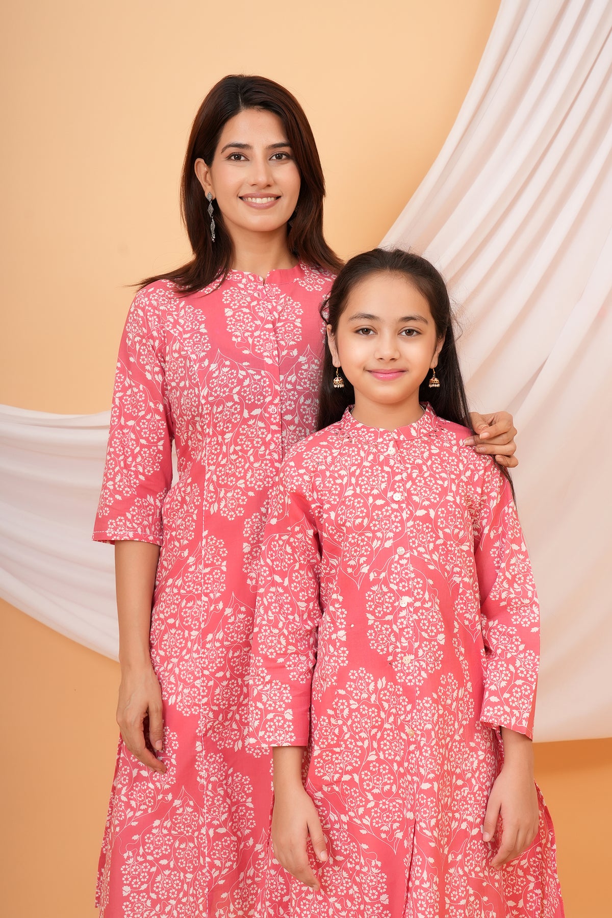 Maa and Beti in matching pink floral jaal printed kurtis