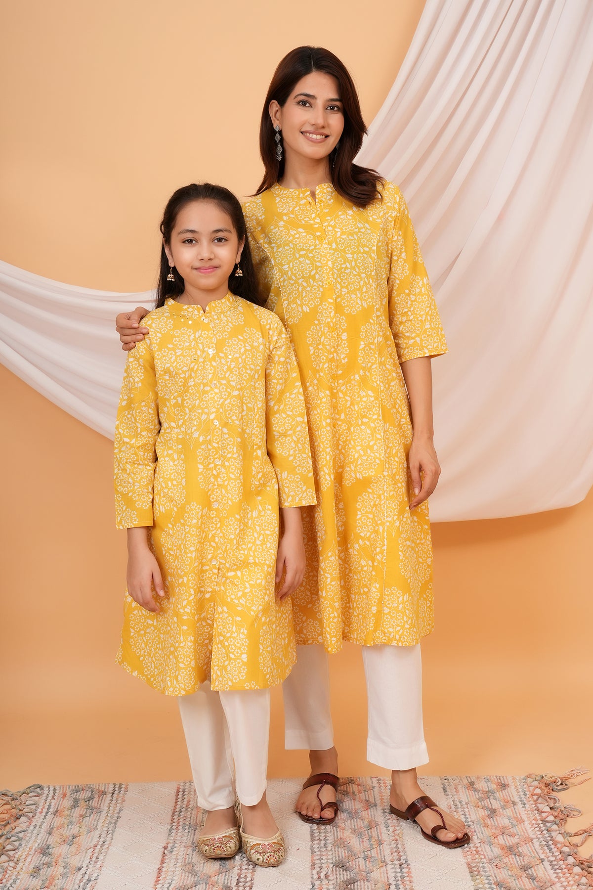 Maa and Beti in matching yellow floral jaal printed kurtis