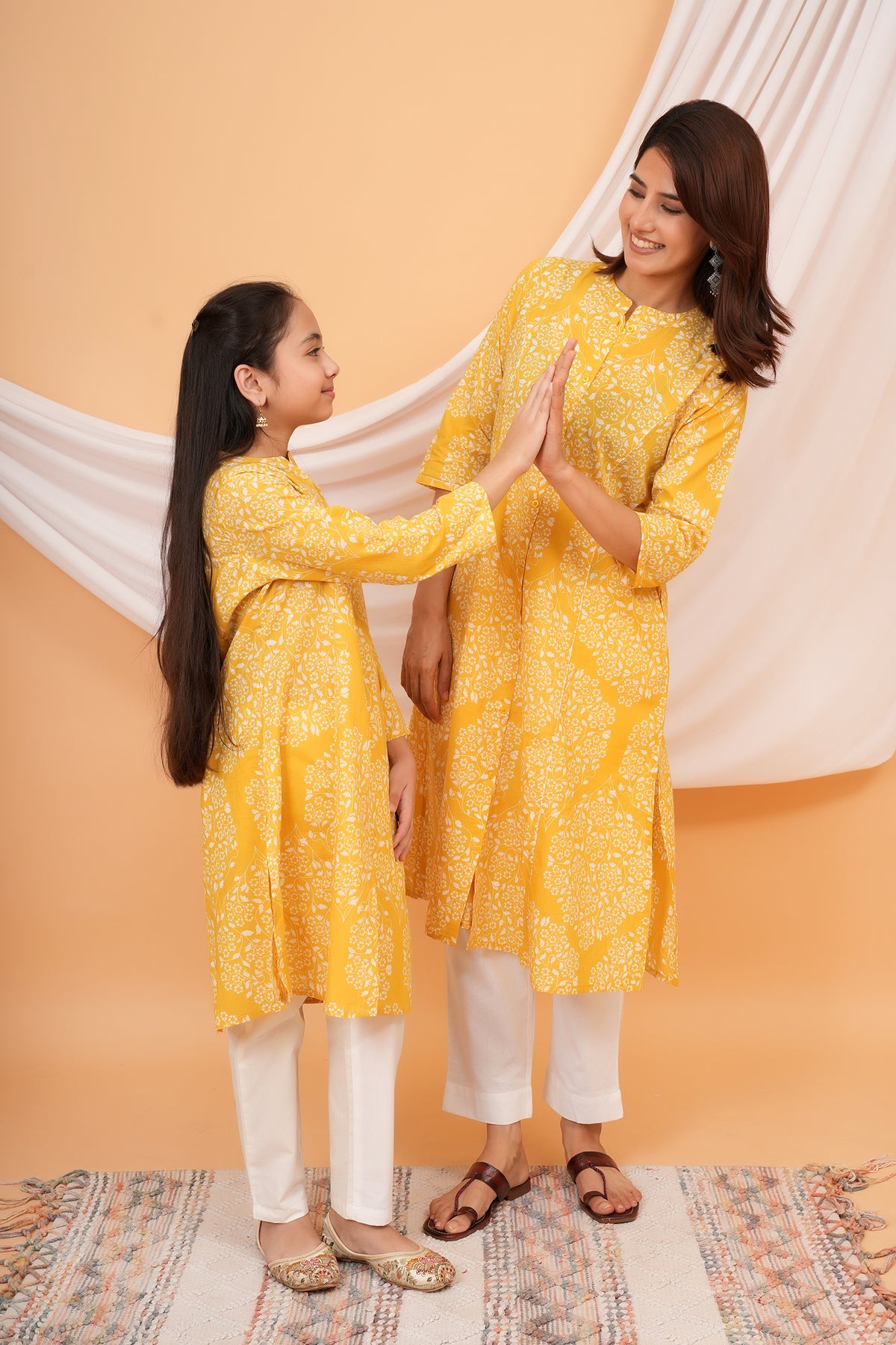 Maa and Beti in matching yellow floral jaal printed kurtis