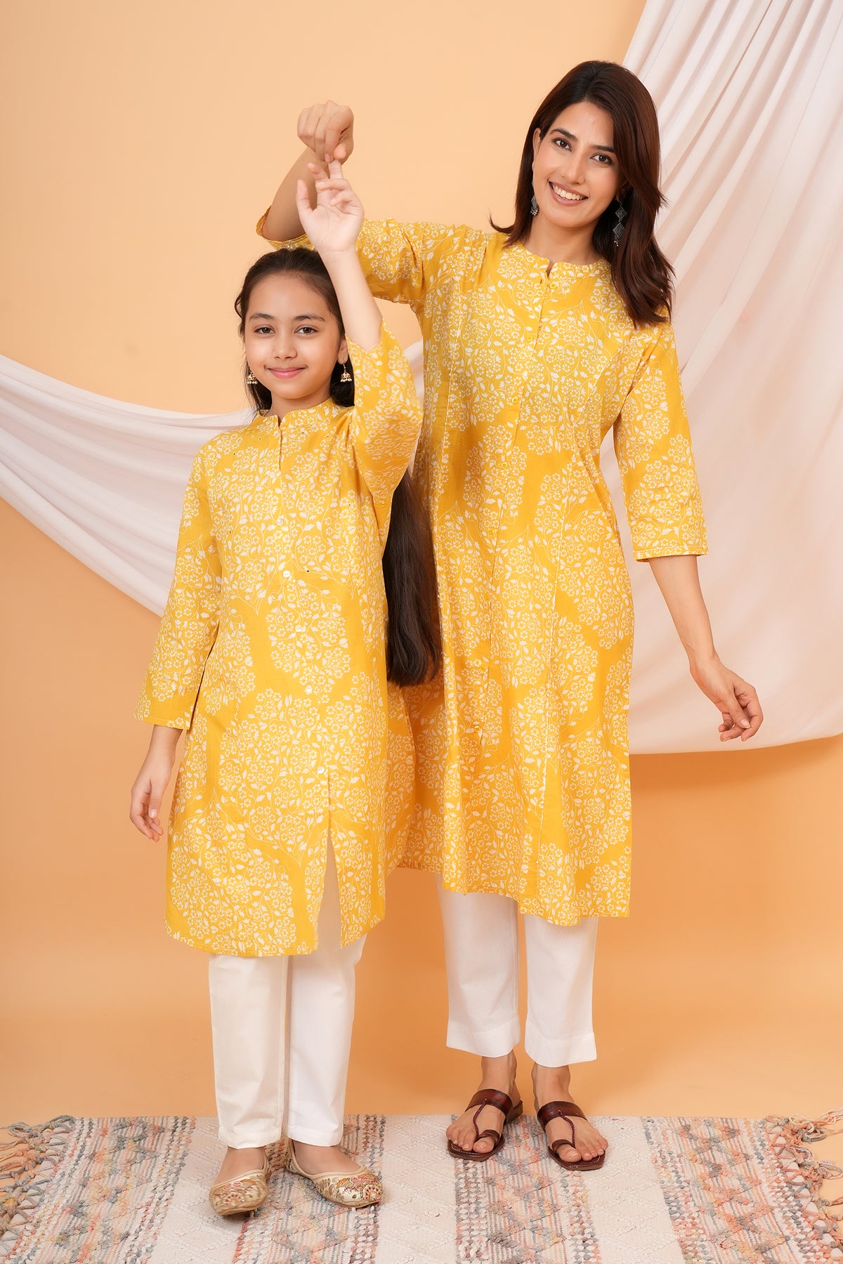Maa and Beti in matching yellow floral jaal printed kurtis